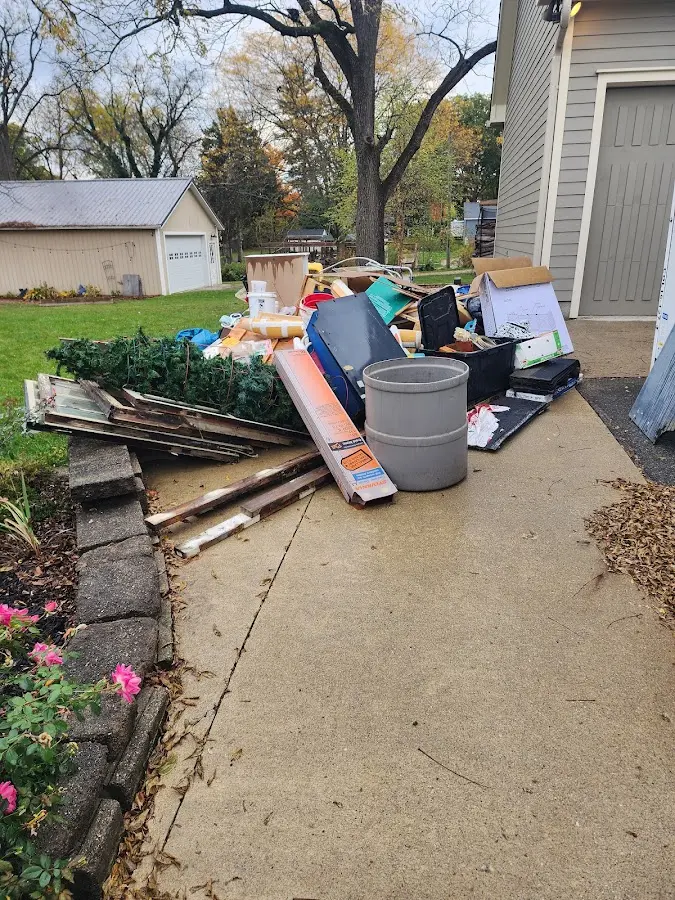 Dumpster being loaded with debris for Residential Dumpster Rental in Triangle